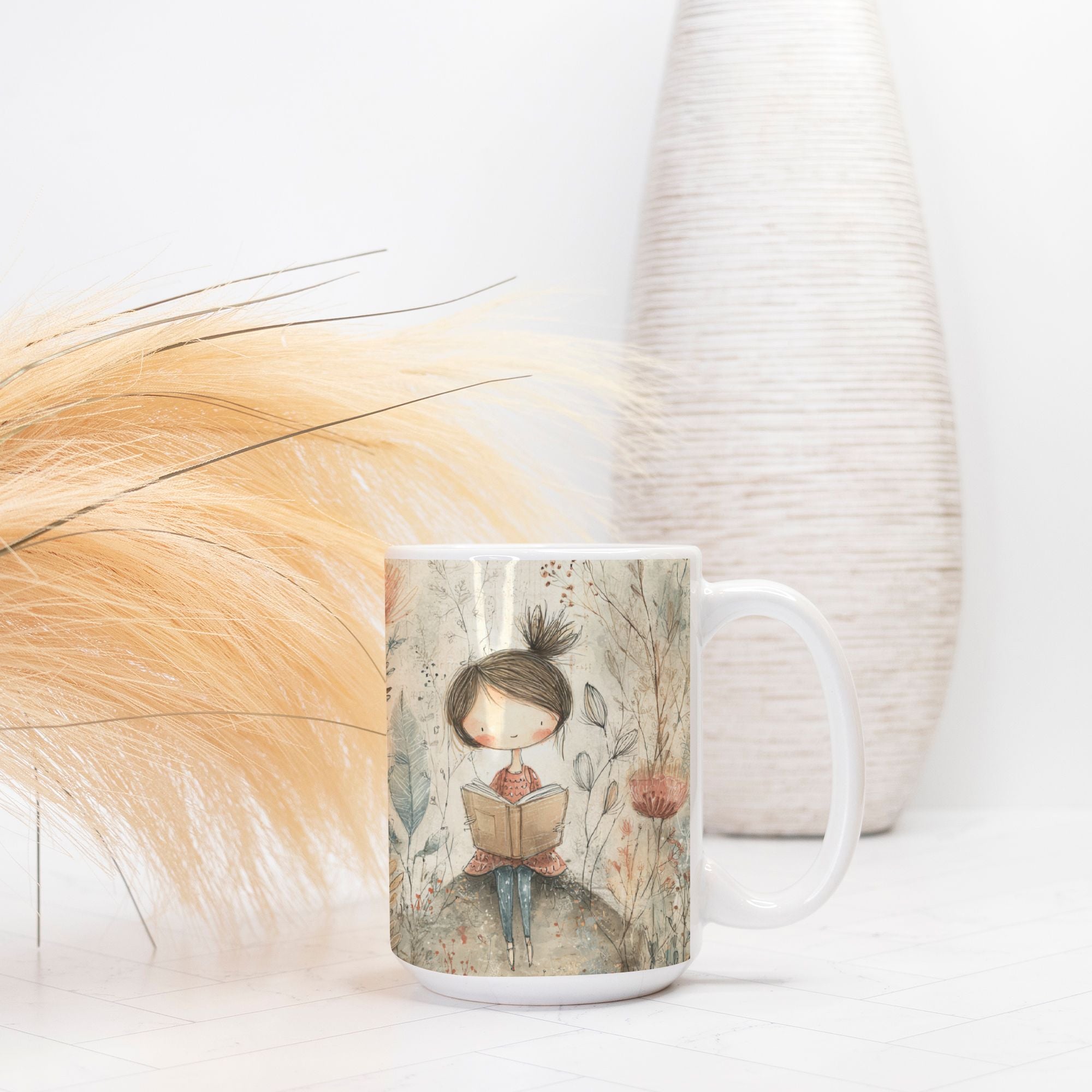 Mug with a design of a girl reading a book, placed on a light surface with decorative elements.