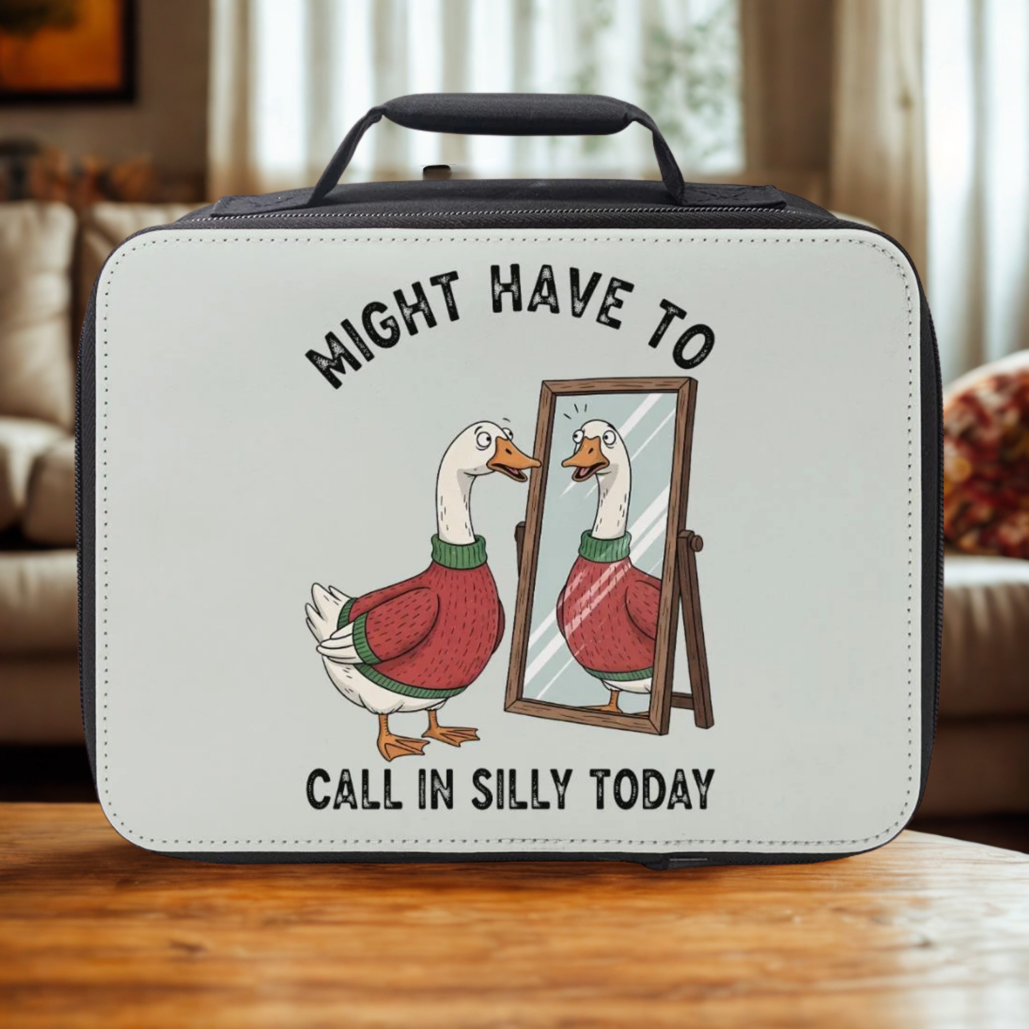 Lunch bag with a cartoon goose and mirror design on a wooden coffee table in a cozy living room.