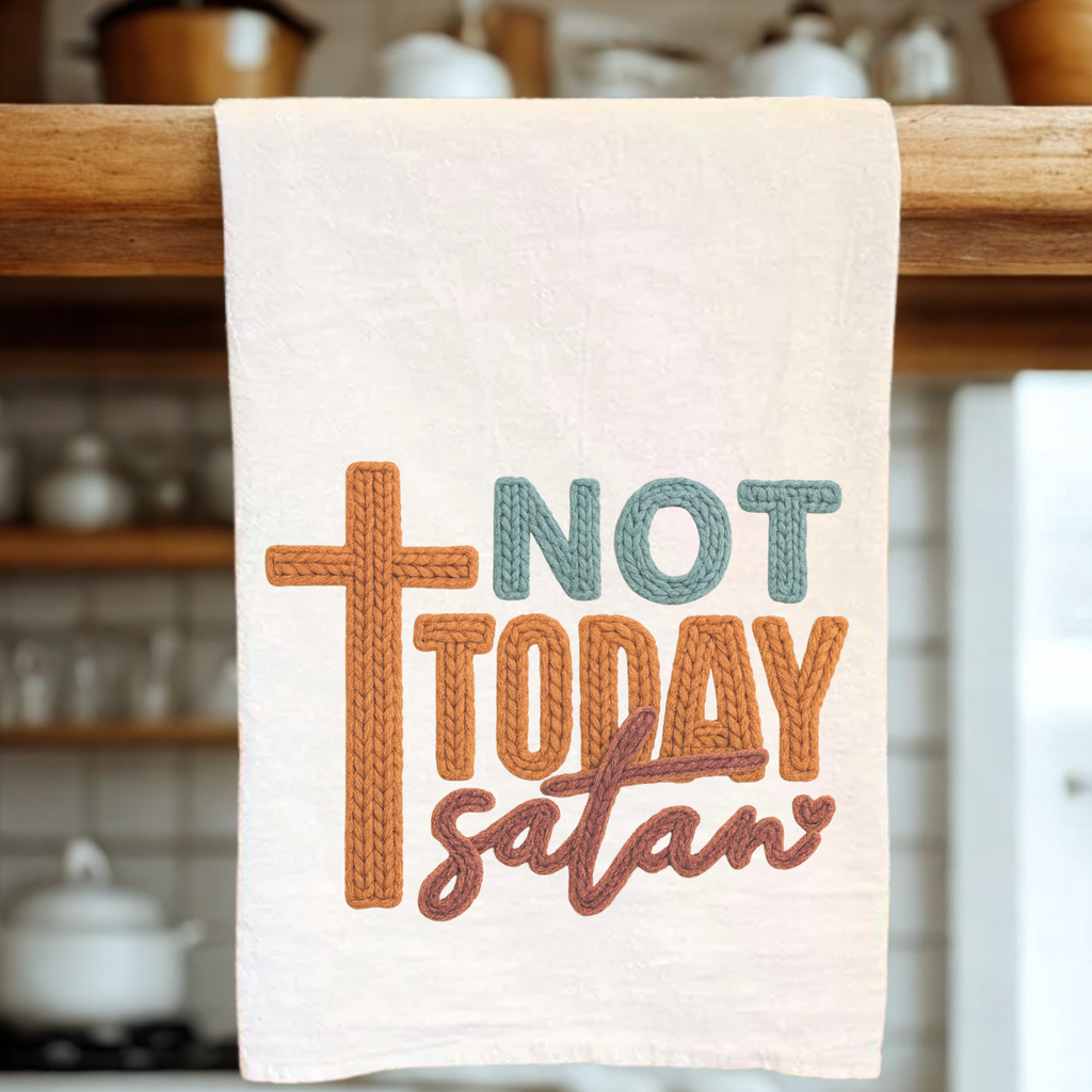 Embroidered design tea towel with 'Not Today Satan' text on a wooden rack in a kitchen setting