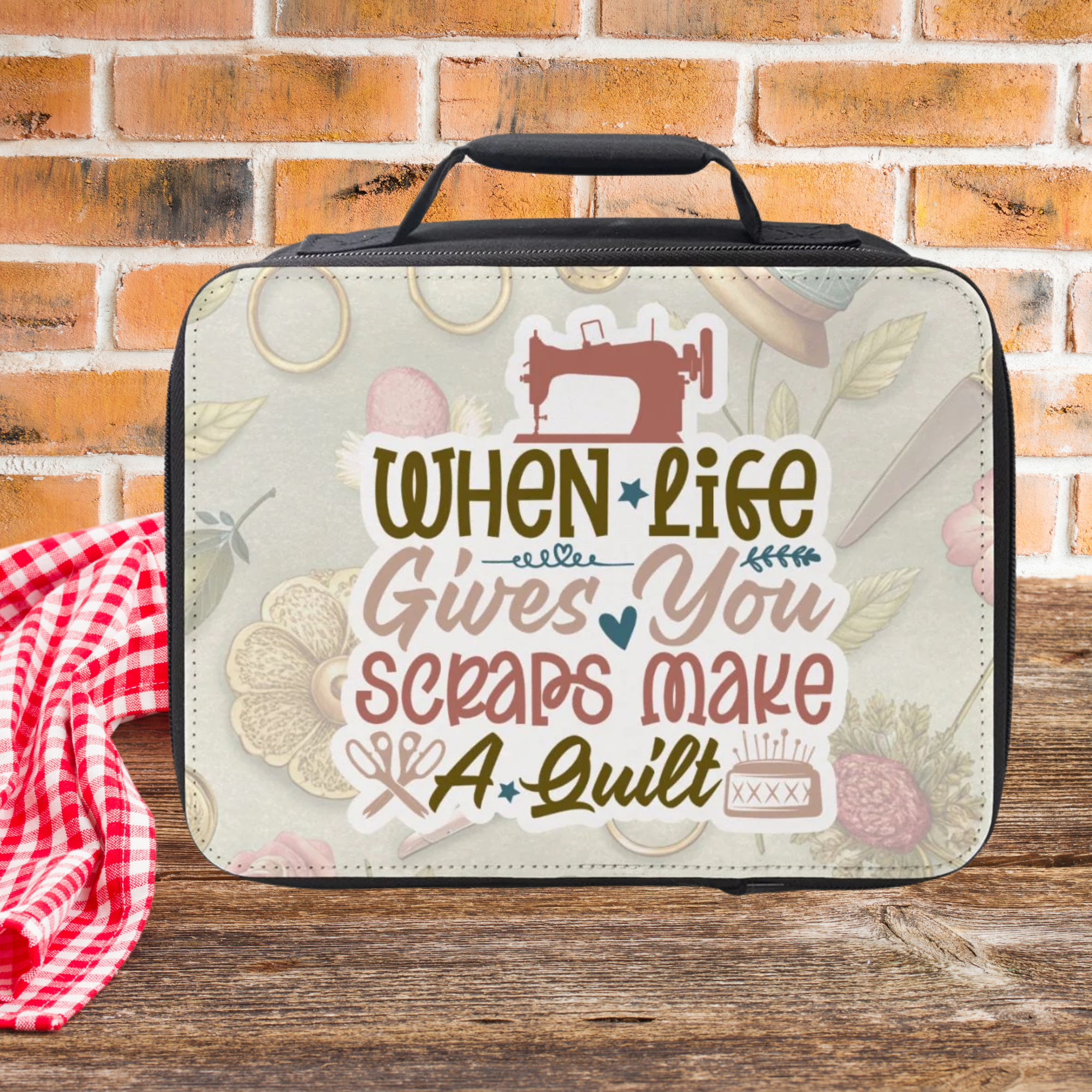Insulated lunch bag with a Sewing & quilt-themed design on a wooden picnic table and brick wall background